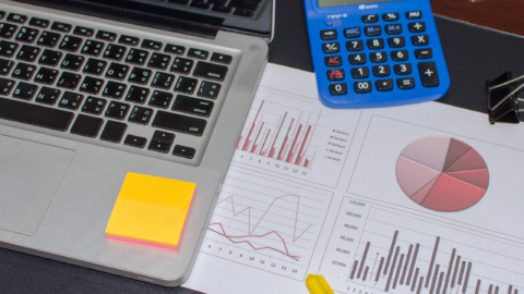 Laptop beside a tax projection worksheet