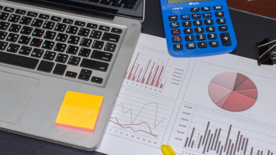 Laptop beside a tax projection worksheet